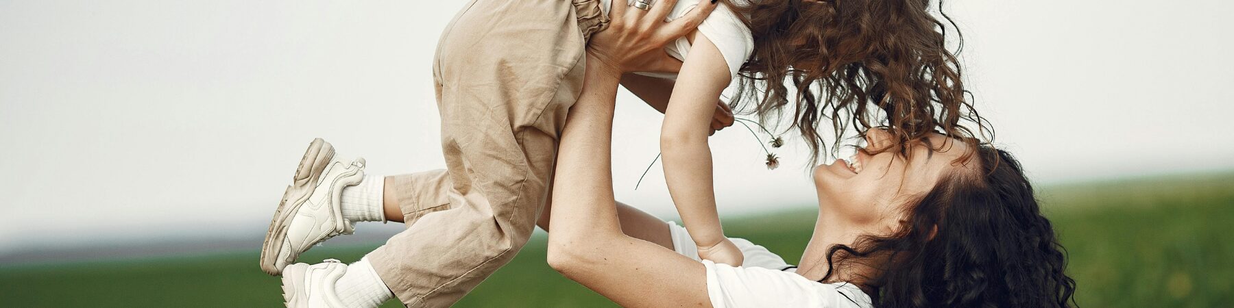 Mother lifting her toddler in the air outdoors with Mother's Day Gift Guide text overlay — Willowbrook Shopping Centre