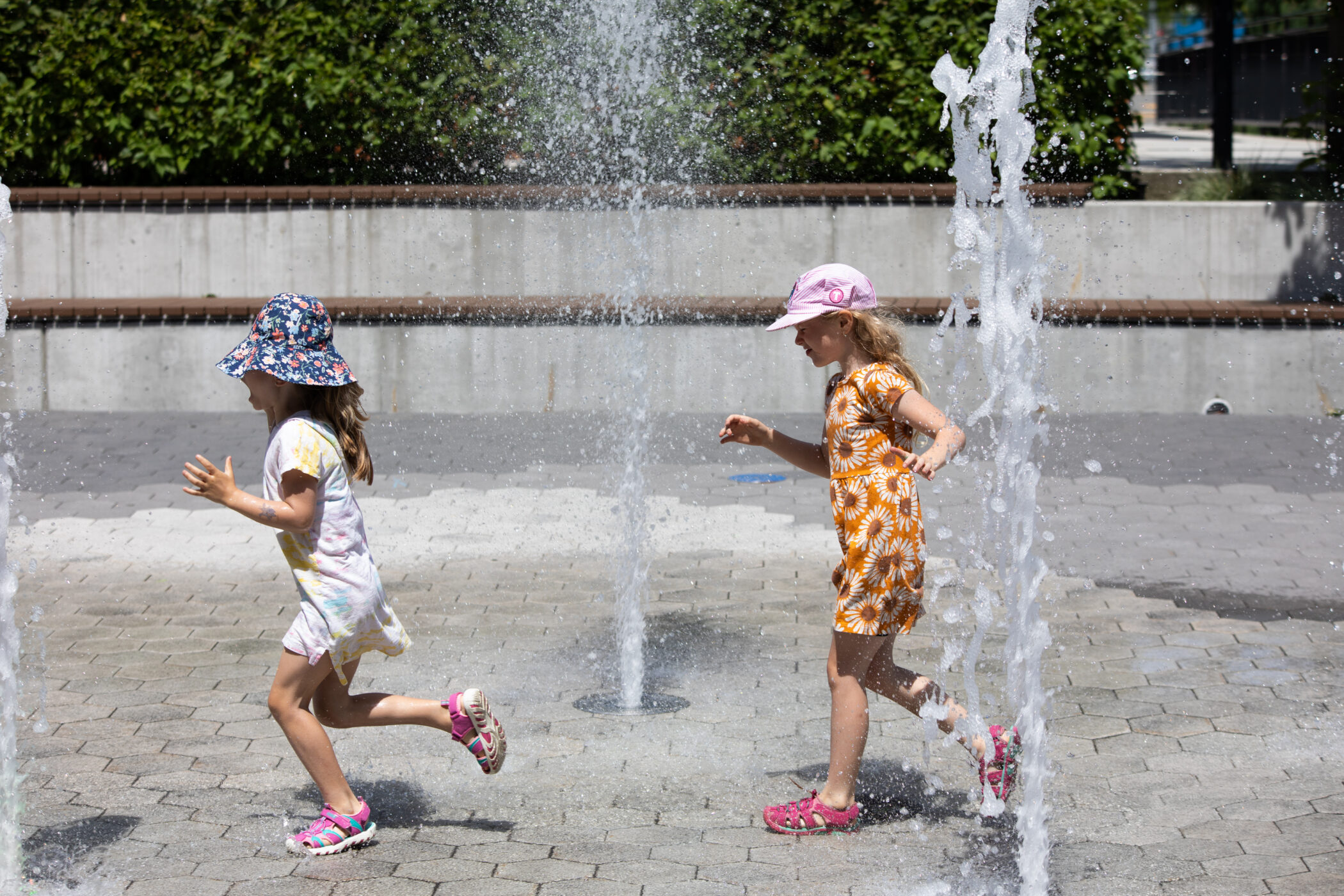 Children playing in the water feature at The Courtyard