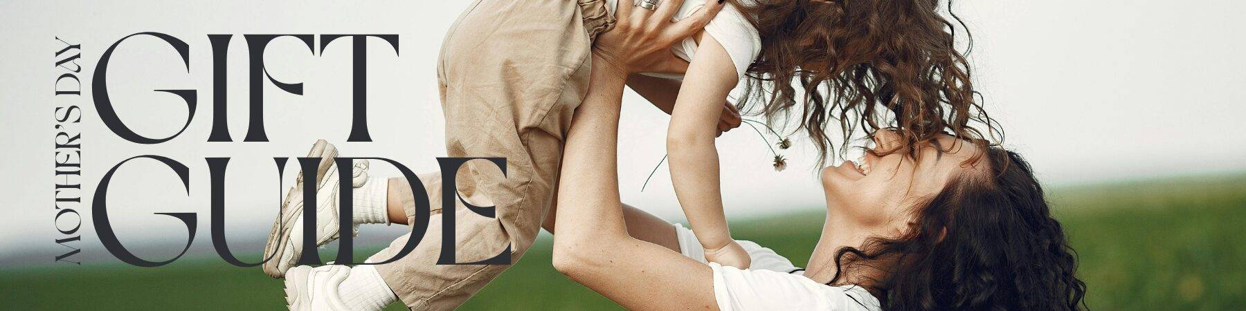 Mother lifting her toddler in the air outdoors with Mother's Day Gift Guide text overlay — Willowbrook Shopping Centre
